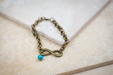 Load image into Gallery viewer, Handmade Bronze Infinity Bracelet with Turquoise Sky Bead
